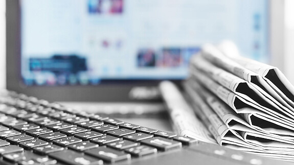 Newspapers and Laptop. Different Concepts for News - Network or
