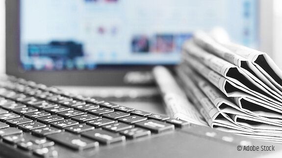 Newspapers and Laptop. Different Concepts for News - Network or