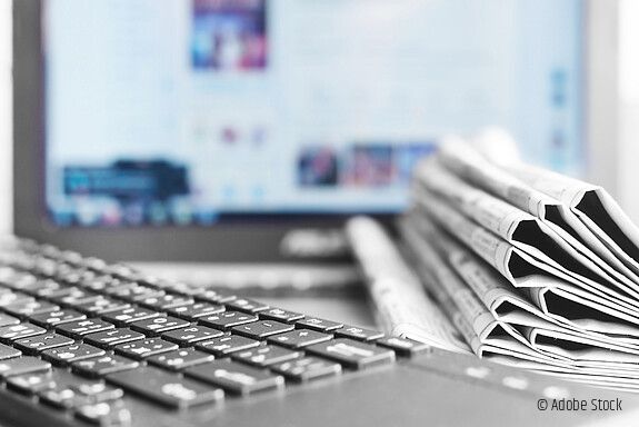 Newspapers and Laptop. Different Concepts for News - Network or